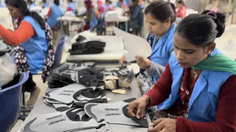 Zen Barefoot Workers at a Zen Barefoot factory assemble shoes